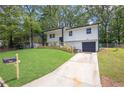 This angle showcases the property's charming exterior, complete with a well-manicured lawn at 2184 Cherokee Valley Cir, Lithonia, GA 30058