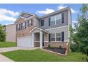Beautiful two-story house with a brick and siding exterior, featuring a well-kept lawn and attractive landscaping at 3650 River Rock Rd, Lithonia, GA 30038
