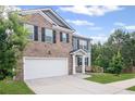 Inviting two-story home with a brick front and siding, showcasing a clean driveway and lush green lawn at 3650 River Rock Rd, Lithonia, GA 30038