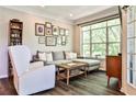 Bright living room featuring a comfortable gray sectional and large window with backyard views at 955 Juniper Ne St # 4332, Atlanta, GA 30309