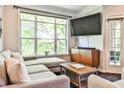 Cozy living room with a comfortable sectional, TV, and ample natural light at 955 Juniper Ne St # 4332, Atlanta, GA 30309