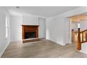 Bright living room featuring hardwood floors, a fireplace, and white walls at 2025 Oakley Se Trce, Smyrna, GA 30080