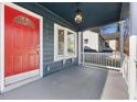 Inviting front porch features a vibrant red door, bay window and classic white railing at 2584 Oldknow Dr, Atlanta, GA 30318