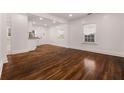 Spacious living room featuring gleaming hardwood floors, white walls and ample natural light at 2584 Oldknow Dr, Atlanta, GA 30318