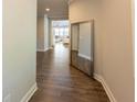 Hallway features wood floors, neutral paint, and a mirror, creating an inviting space at 360 Hayden Cir, Woodstock, GA 30189