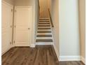 Entryway showcases a staircase with wood treads, paired with elegant white trim at 360 Hayden Cir, Woodstock, GA 30189
