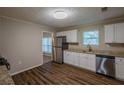 Modern kitchen boasting stainless steel appliances, granite countertops, and wood-look floors at 4650 Big Valley Ct, Stone Mountain, GA 30083