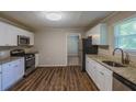 Well-lit kitchen featuring stainless steel appliances, granite countertops, and sleek white cabinetry at 4650 Big Valley Ct, Stone Mountain, GA 30083