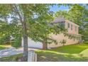 Side view of home with a well-maintained lawn, brick, and vinyl siding at 484 Cathedral Dr, Mcdonough, GA 30253