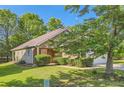 Inviting single-story home with lush landscaping, brick accents, and a two-car garage at 484 Cathedral Dr, Mcdonough, GA 30253