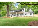 Beautiful home with a large front porch, modern black trim, and a spacious lawn at 550 Stewart Nw Ave, Marietta, GA 30064