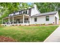 A beautifully renovated home with white brick, a covered porch, and a well-manicured front yard at 550 Stewart Nw Ave, Marietta, GA 30064