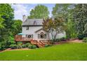 Expansive backyard featuring a wooden deck, lush green lawn, and mature trees, ideal for outdoor living and entertaining at 3953 Lorien Nw Way, Kennesaw, GA 30152