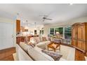 Cozy living room with hardwood floors, comfortable sofas, and a view into the kitchen and dining area at 3953 Lorien Nw Way, Kennesaw, GA 30152