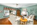 Cozy living room featuring hardwood floors, a decorative fireplace, and stylish furnishings for relaxed living and entertaining at 3953 Lorien Nw Way, Kennesaw, GA 30152