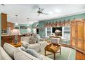 Inviting living room with comfortable sofas, a ceiling fan, and a view of the open-concept kitchen and dining area at 3953 Lorien Nw Way, Kennesaw, GA 30152