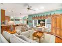 Cozy open-concept living room featuring comfortable seating, natural light, and seamless flow into the kitchen area at 3953 Lorien Nw Way, Kennesaw, GA 30152