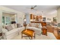 Open-concept living room flowing into the kitchen, featuring hardwood floors and comfortable furnishings at 3953 Lorien Nw Way, Kennesaw, GA 30152
