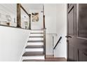 Bright foyer with hardwood floors, an open staircase, and modern railing at 1386 Pineglen Dr, Riverdale, GA 30296