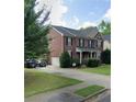 Brick home with a long driveway and attached garage, surrounded by green trees at 2667 Hampton Park Dr, Marietta, GA 30062