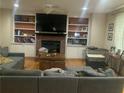 Comfortable living room with a brick fireplace, built-in bookshelves, and plush seating at 2667 Hampton Park Dr, Marietta, GA 30062