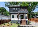 Contemporary two-story home with a stylish balcony, landscaped front yard, and appealing curb appeal at 32 Wadley Nw St, Atlanta, GA 30314