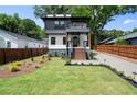 Charming home with a well-manicured lawn, wooden fence, and a modern exterior at 32 Wadley Nw St, Atlanta, GA 30314