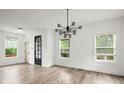 Bright and airy living room with stylish chandelier, modern flooring, and large windows at 32 Wadley Nw St, Atlanta, GA 30314