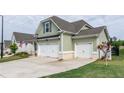 Side view of a lovely home with a three-car garage and well-maintained lawn and landscaping at 98 Heritage Pointe Dr, Villa Rica, GA 30180