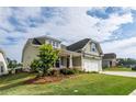 Inviting home exterior showcasing the lush lawn and landscaping with a partial view of the driveway at 98 Heritage Pointe Dr, Villa Rica, GA 30180