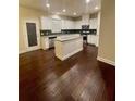 Modern kitchen with white cabinets, stainless steel appliances, and a granite island at 2431 Kingston Heath Way, Marietta, GA 30008