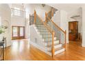 Elegant foyer with hardwood floors, a staircase with iron railings, and a view of the front entrance at 3512 Centerville Rosebud Rd, Snellville, GA 30039