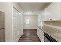 Kitchen featuring modern appliances, ample storage, granite counters, and vinyl plank flooring at 733 San Fernando Se Dr, Smyrna, GA 30080