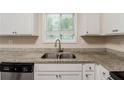 Bright kitchen with a stainless steel sink and granite countertops, illuminated by natural light at 733 San Fernando Se Dr, Smyrna, GA 30080