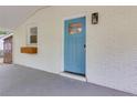 Close up of light blue front door with glass inset, white brick, and flower box at 2917 Reveille Se Cir, Atlanta, GA 30316