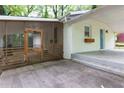 Home exterior with screened-in porch and covered parking area with a light blue front door at 2917 Reveille Se Cir, Atlanta, GA 30316