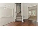 Inviting foyer with hardwood floors and staircase leading to the upper level at 3570 Steve Nw Dr, Marietta, GA 30064