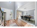 Bright foyer with wood floors leading to a dining area and a white front door at 3707 Lance Bluff Ln, Duluth, GA 30097
