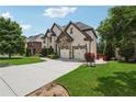 Charming brick home with a stone facade, mature trees, and a long driveway at 5068 Bentwater Sw Ln, Lilburn, GA 30047