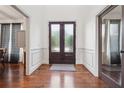 Welcoming foyer features hardwood flooring and doors with frosted windows at 5068 Bentwater Sw Ln, Lilburn, GA 30047