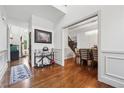 Grand foyer with hardwood floors, elegant trim, and views of the dining room and living room at 5068 Bentwater Sw Ln, Lilburn, GA 30047
