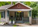 Inviting front porch with decorative columns, seating, and beautiful landscaping at 770 Ormewood Se Ave, Atlanta, GA 30312