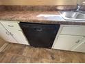 This kitchen includes a black Amana dishwasher under the sink and laminate countertop at 1090 Forest Path, Stone Mountain, GA 30088