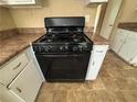 The kitchen boasts a freestanding Hotpoint range with a black finish at 1090 Forest Path, Stone Mountain, GA 30088