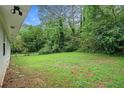 A sprawling backyard with lush greenery, providing ample space for outdoor activities and relaxation at 2406 Tilson Rd, Decatur, GA 30032