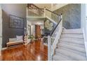 Grand two-story foyer with hardwood floors, staircase, and elegant decorative details at 4023 Port Springs Trl, Snellville, GA 30039