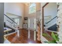 Bright, two-story foyer with hardwood floors, large arched window and decorative floral accents at 4023 Port Springs Trl, Snellville, GA 30039