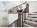 Bright, modern staircase with iron spindles leading to second-floor dining area at 6807 Prelude Dr, Atlanta, GA 30328