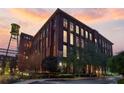 Exterior view of red brick building with large windows against a sunset sky at 170 Boulevard Se # 115E, Atlanta, GA 30312