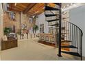 Open living space with spiral staircase, dining area, and brick accent wall at 170 Boulevard Se # 115E, Atlanta, GA 30312